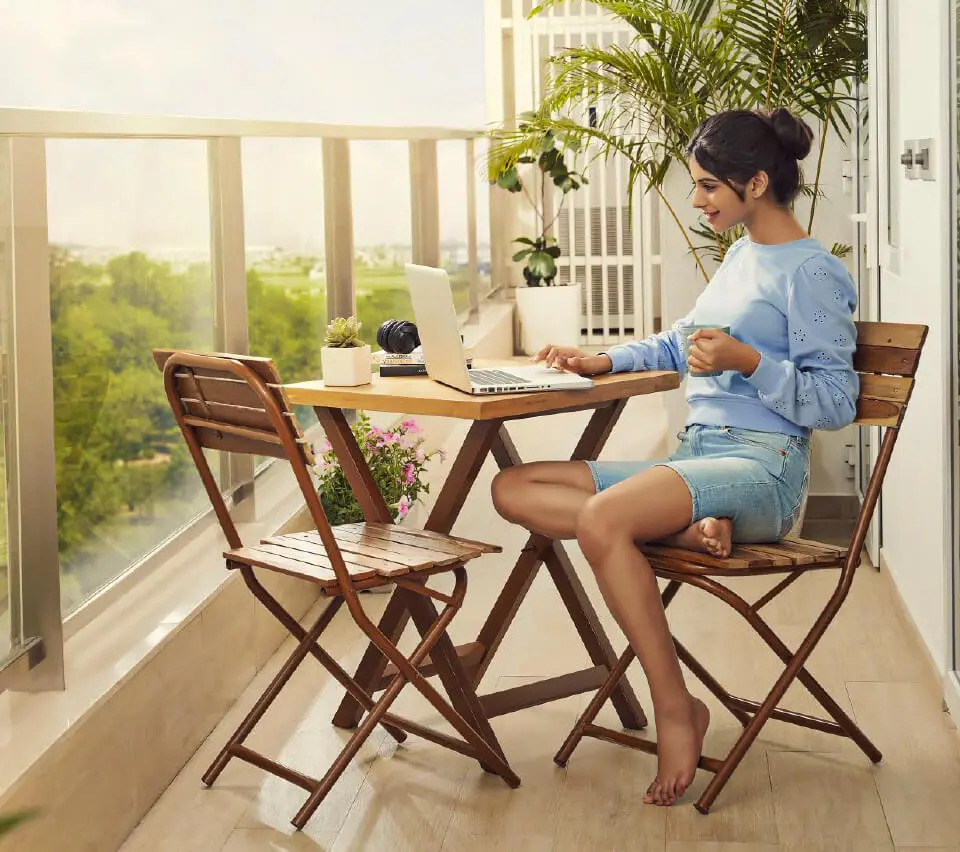 Luxury balcony seating area with modern outdoor furniture and relaxing lifestyle ambiance.